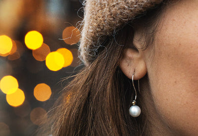 Trollbeads earring, worn by a model with a winter beanie
