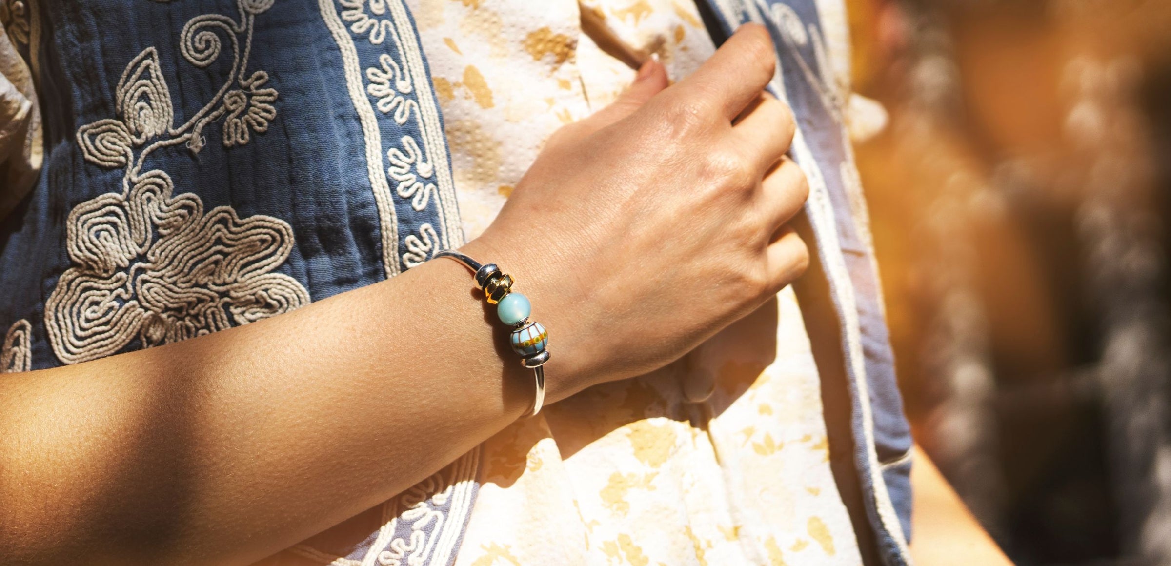 Woman wearing silver power bangle with beads
